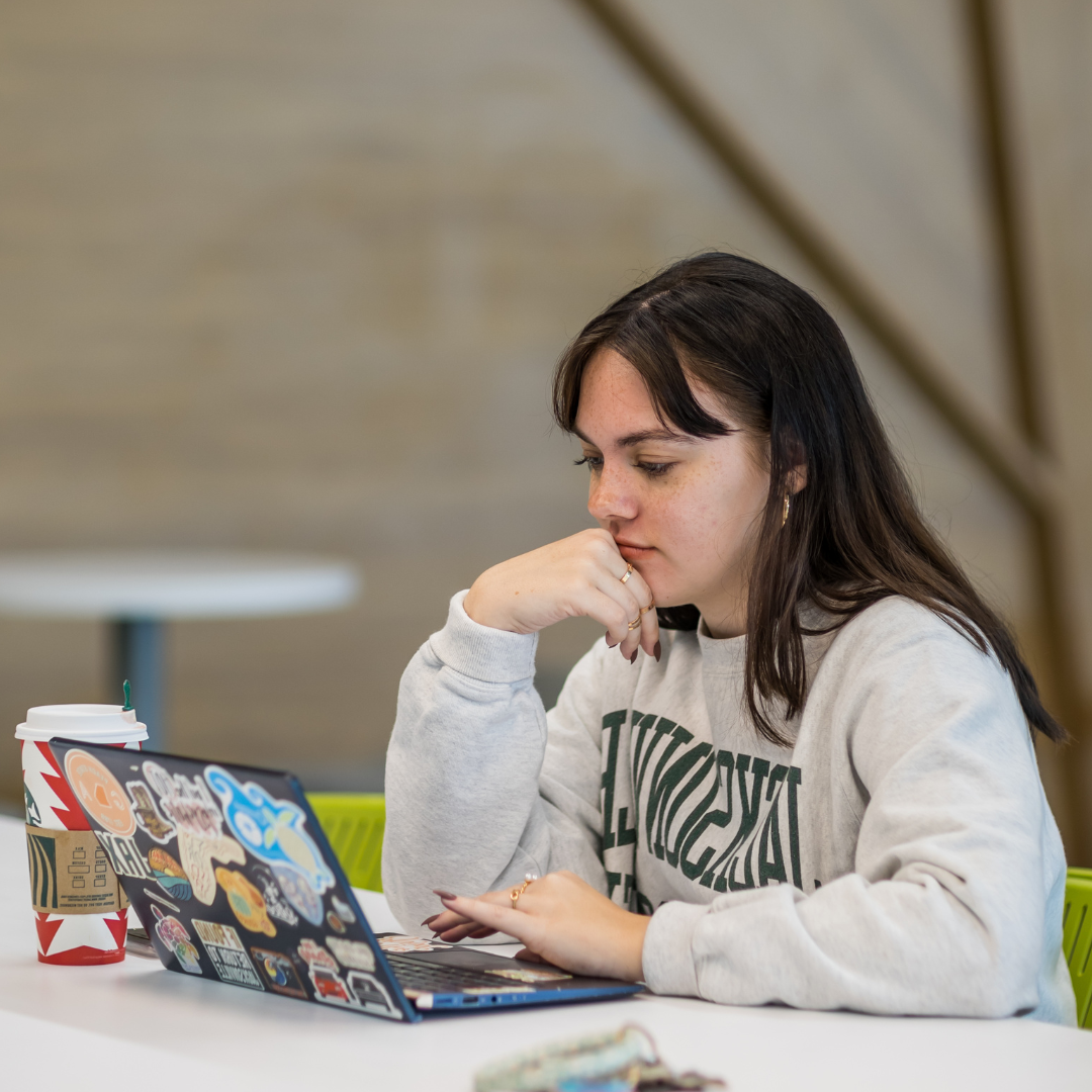 Female student browsing on her laptop.